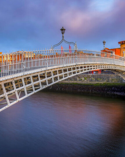 Scenic view of historic bridge over calm river near charming hotel in city centre, perfect spot for relaxation and exploration.
